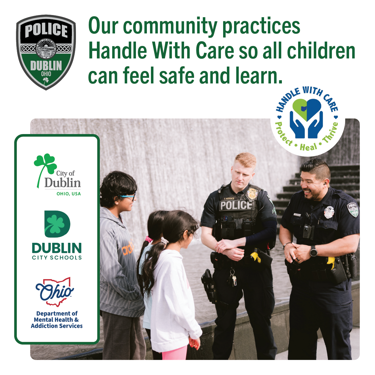 Two Dublin Police officers talking to three kids in Riverside Crossing Park.